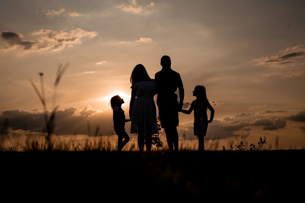 Family walking together at sunset.
